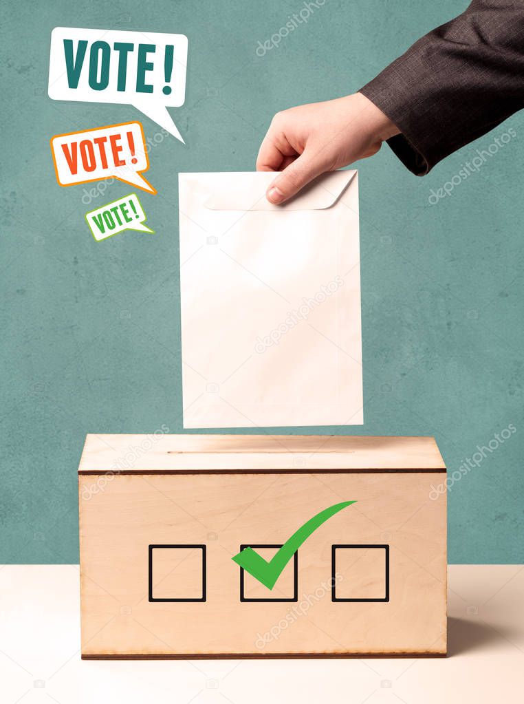 placing a voting slip into a ballot box