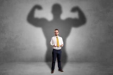 Businessman with muscular shade behind his back clipart