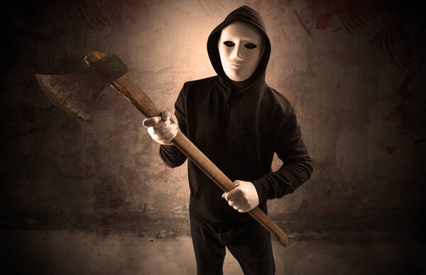 Armed assassin in an empty bloody room concept