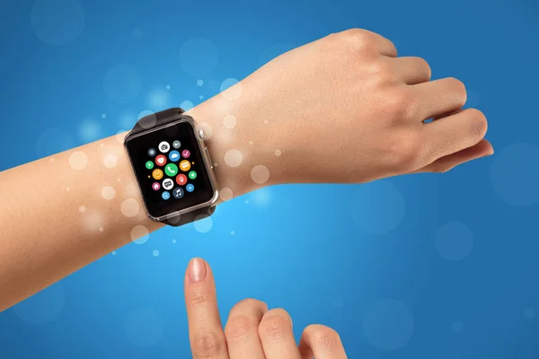 Female hand with smartwatch and app icons — Stock Photo, Image