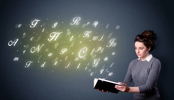 Young lady holding book with letters — Stock Photo, Image