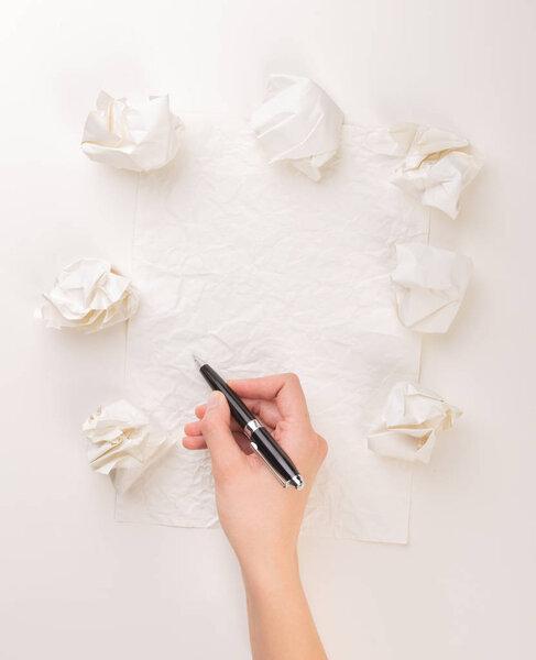 Writing hand in crumpled paper