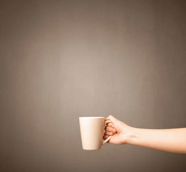Female hand holding tea mug