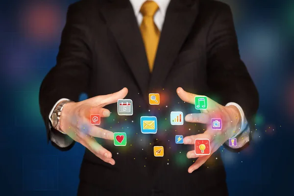 Businessman holding application icons — Stock Photo, Image