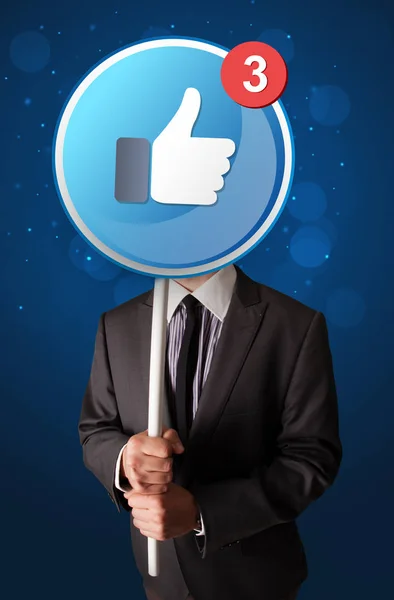 Geschäftsmann mit Facebook-Schild — Stockfoto