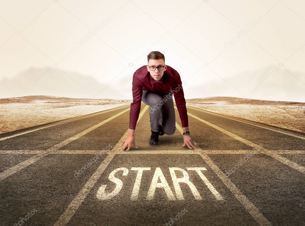 Businessman kneeling in ready position