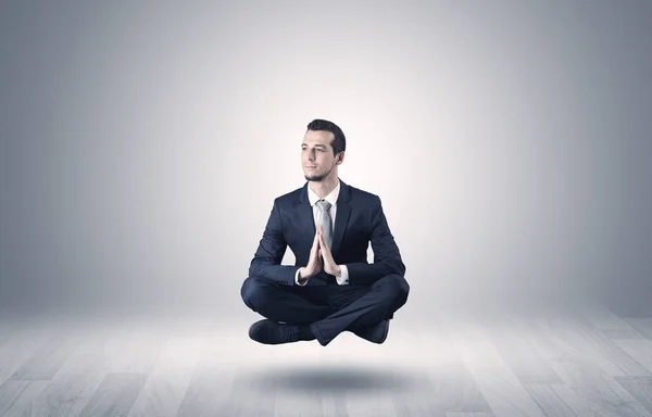 Businessman meditates in an empty space concept — Stock Photo, Image