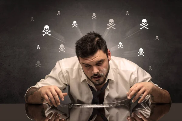 Drunk man sitting at table with skulls concept — Stock Photo, Image