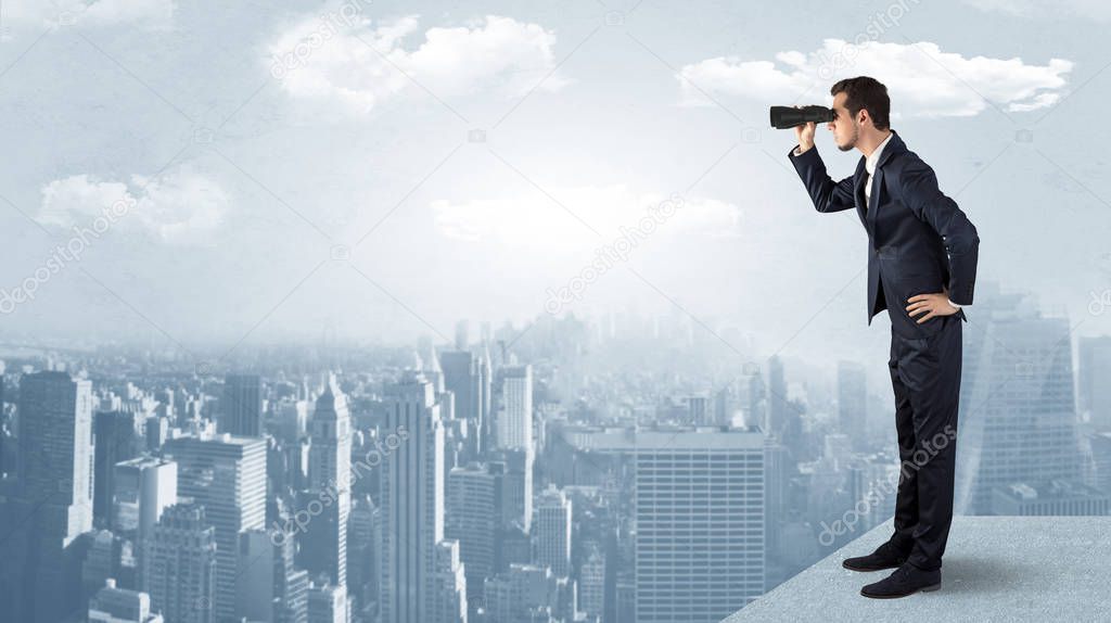 Man looking forward from the top of a skyscraper