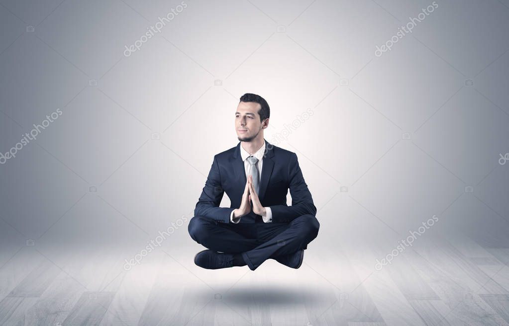 Businessman meditates in an empty space concept
