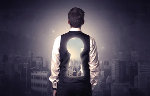 Businessman standing with keyhole on his back — Stock Photo, Image