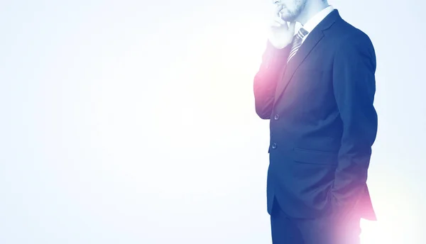 Young businessman standing and thinking — Stock Photo, Image