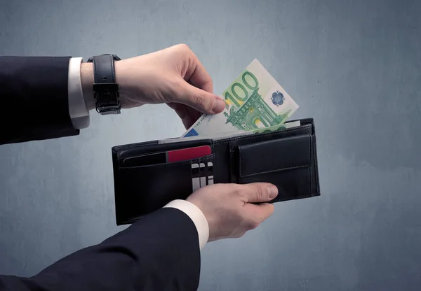 Hand in suit takes out euro from wallet — Stock Photo, Image