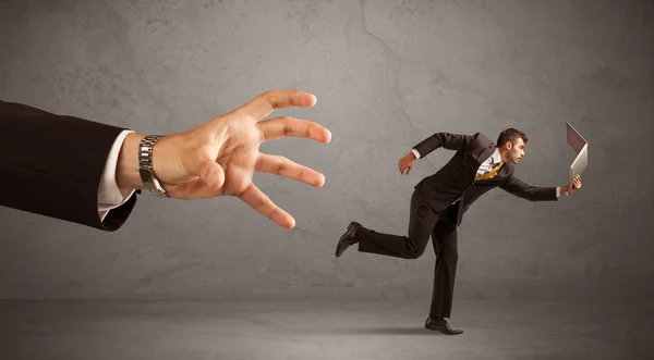 Businessman running from hand — Stock Photo, Image