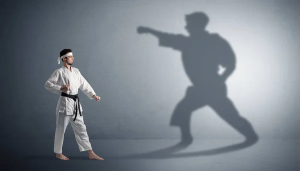 Karate hombre confrontando con su propia sombra —  Fotos de Stock