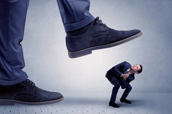 Young businessman getting crushed — Stock Photo, Image