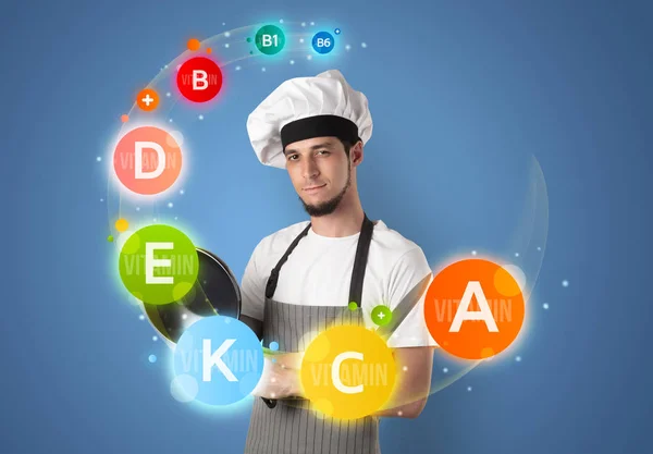 Handsome cook with vitamin concept — Stock Photo, Image