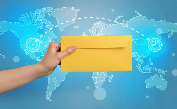 Hand holding envelope with global concept