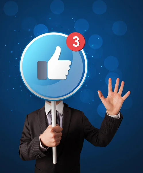 Businessman holding facebook sign — Stock Photo, Image