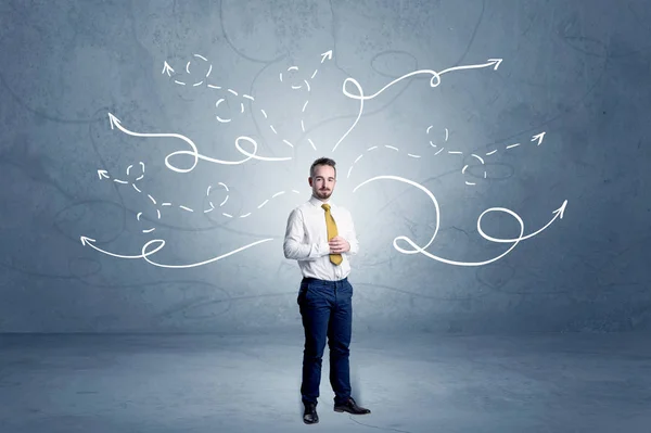 Businessman standing with winding arrows around — Stock Photo, Image