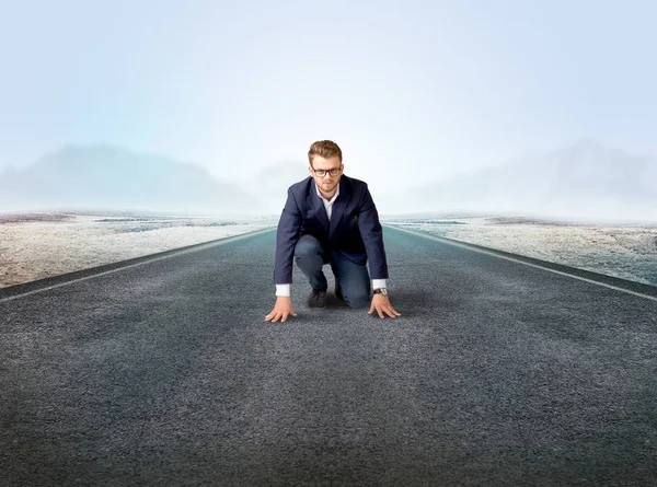 Businessman kneeling in ready position Royalty Free Stock Images