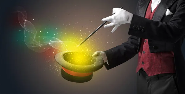 Illusionist hand making trick with wand — Stock Photo, Image