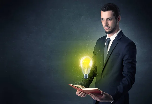 Businessman holding a book. — Stock Photo, Image