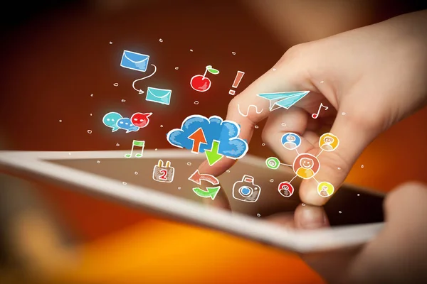 Fingers touching tablet with social icons — Stock Photo, Image