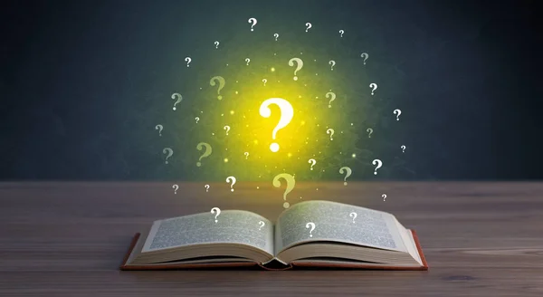 Question marks over book — Stock Photo, Image