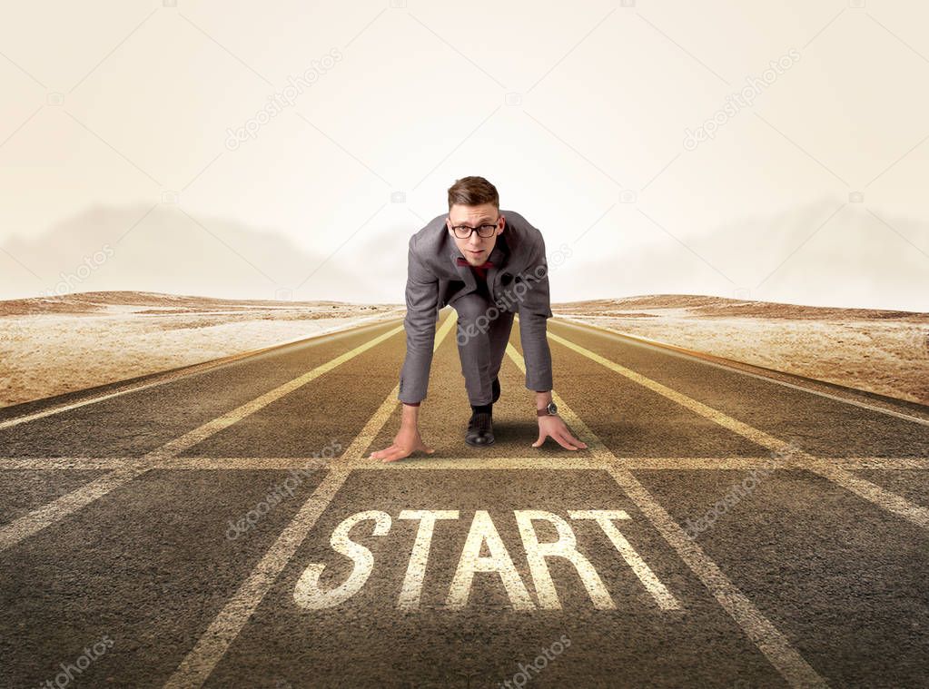 Businessman kneeling in ready position