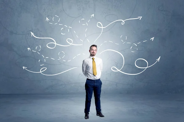 Businessman standing with winding arrows around — Stock Photo, Image