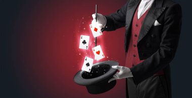 Magician making trick with wand and playing cards clipart