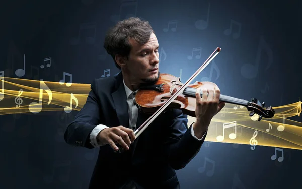Musician playing on violin with notes around — Stock Photo, Image