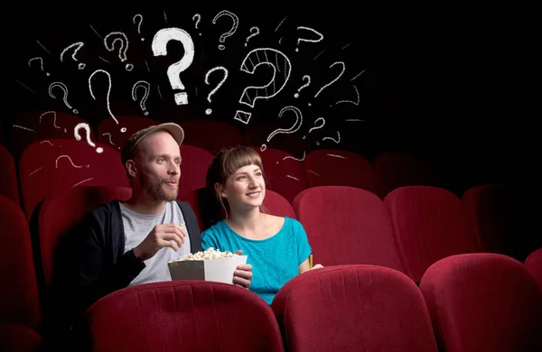 Couple in cinema with questions — Stock Photo, Image