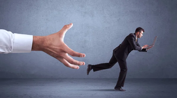 Businessman running from hand — Stock Photo, Image