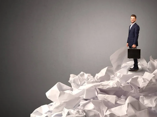 Businessman standing on crumpled paper — Stock Photo, Image