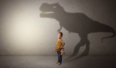 Dinosaurus shadow behind cute boy clipart