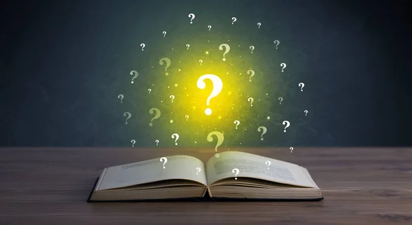 Question marks over book — Stock Photo, Image