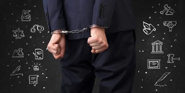 Symbols of courthouse with handcuffed man — Stock Photo, Image