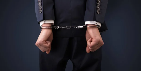 Dark backgrounded close handcuffed man — Stock Photo, Image