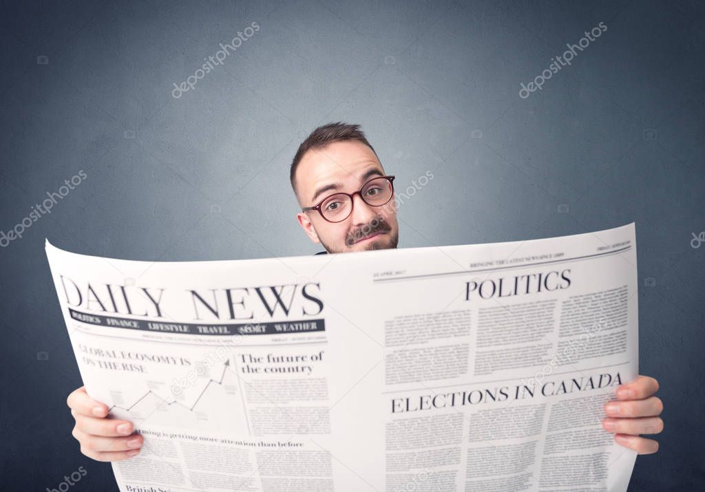 Businessman reading newspaper