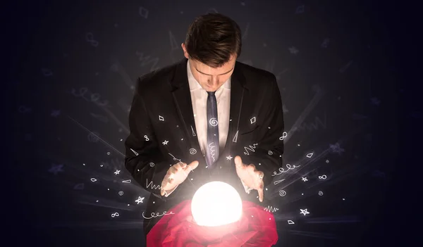 Businessman looking to inspiration in a magic ball and doodle concept — Stock Photo, Image