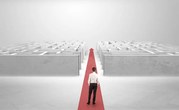 Businessman going straight ahead between two mazes — Stock Photo, Image