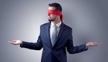 Kapalı göz işadamı bir duvarın önünde