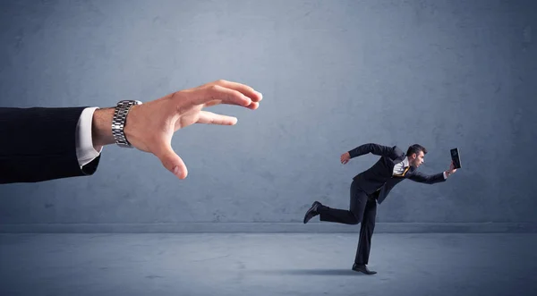 Businessman running from hand — Stock Photo, Image