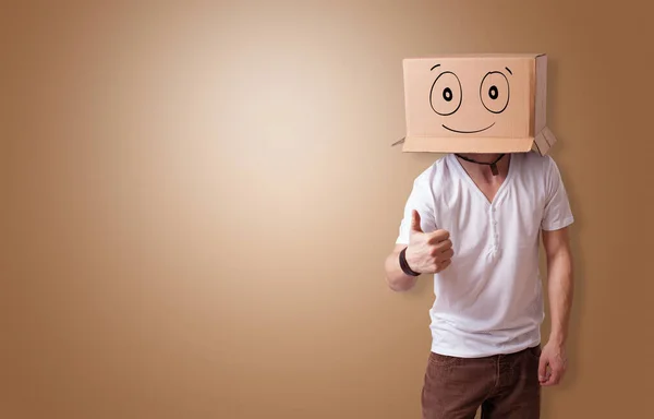 Man with smiling carton box head — Stock Photo, Image