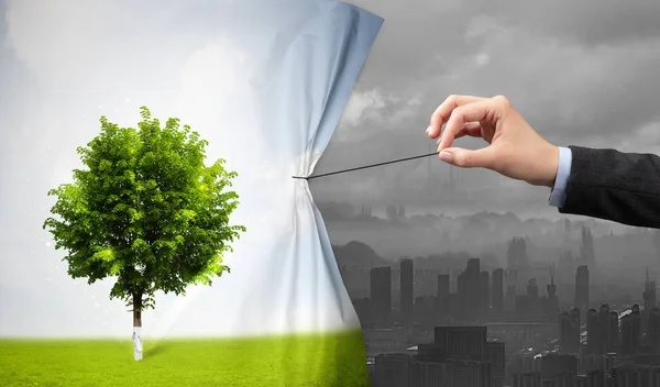 Hand pulling nature cityscape curtain to gray cityscape — Stock Photo, Image