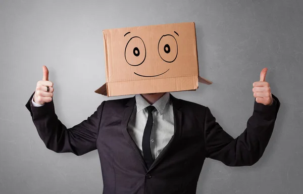 Muž s úsměvem a karton box hlava — Stock fotografie