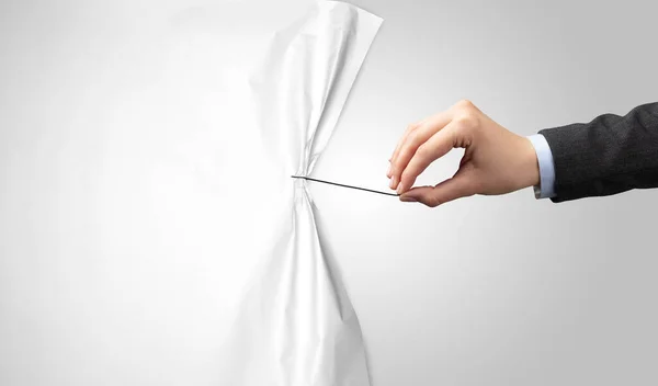 Hand pulling white paper curtain — Stock Photo, Image