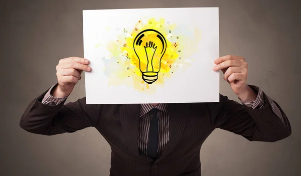 Person holding a paper with colorful bulb concept — Stock Photo, Image